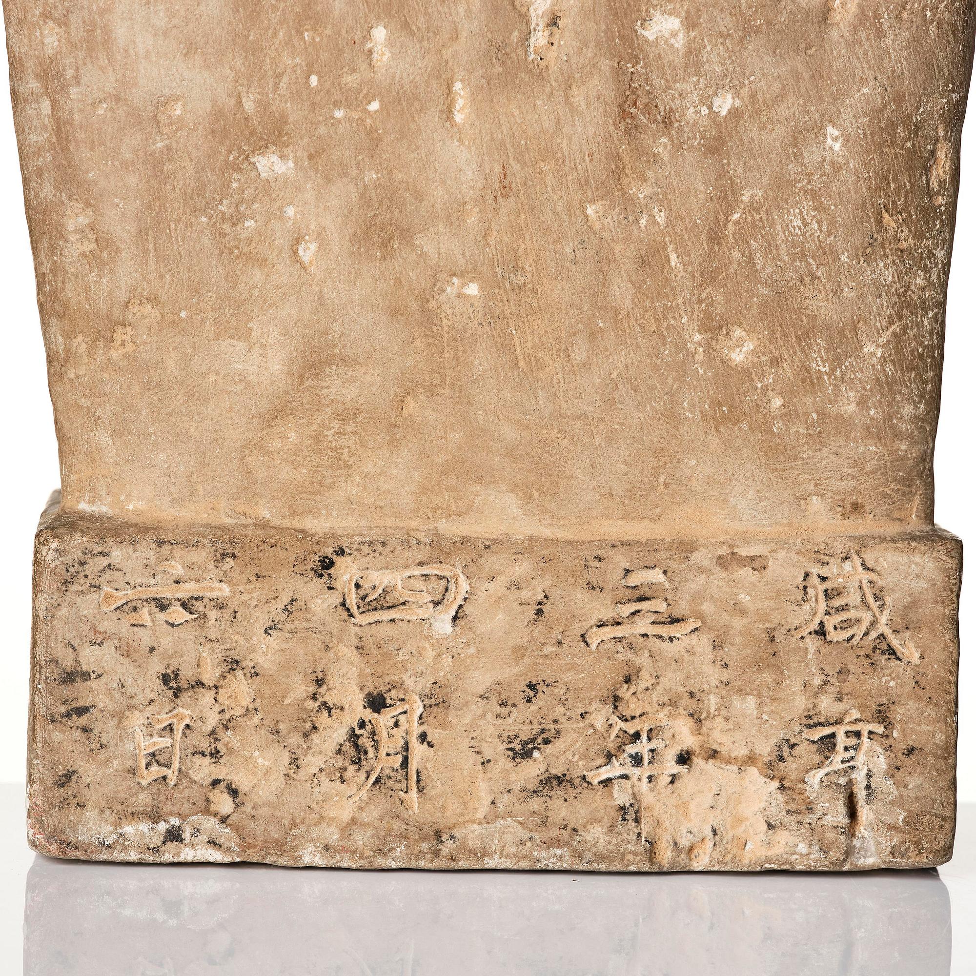 An inscribed limestone Buddhist stele, Tang style, with an inscription the third year of the Xian, corresponding to 672.