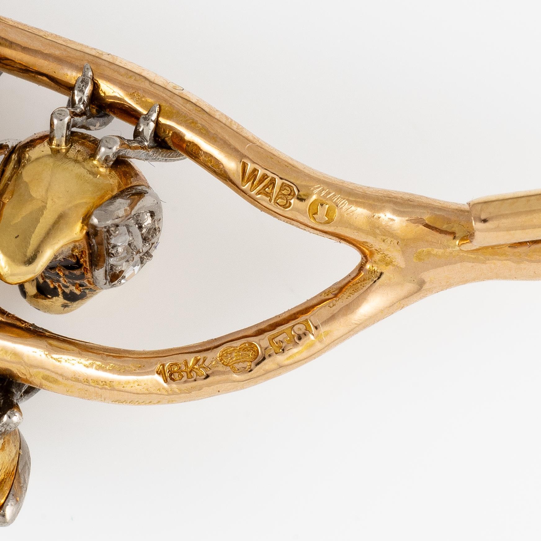 A W.A. Bolin brooch in 18K gold with enamel details and rose-cut diamonds.