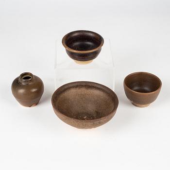 A group of three brown glazed bowls and a jar, South East Asia, 14th/17th Century.