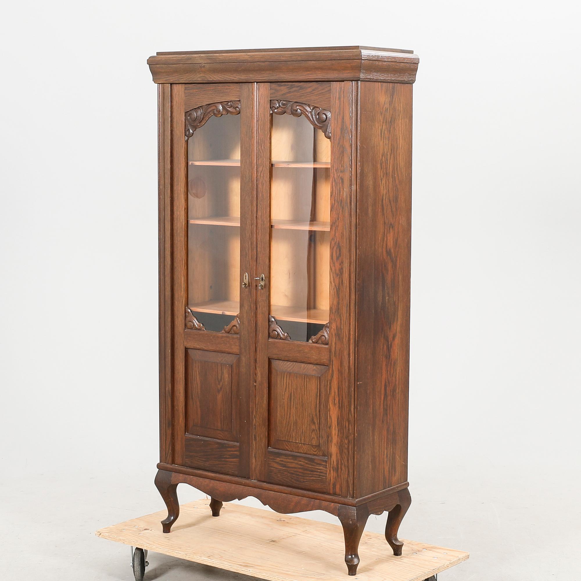 A 1920s oak display cabinet.