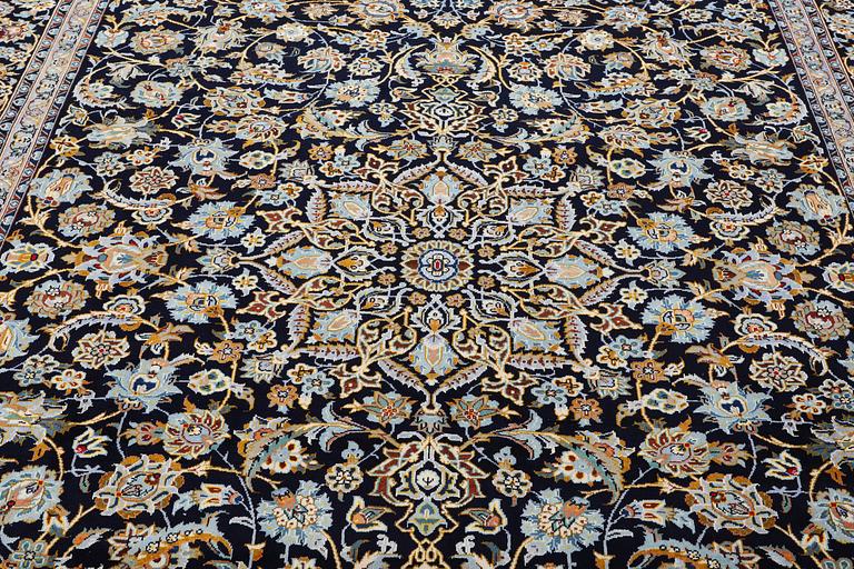 A Kashan carpet, signed, c. 381 x 285 cm.