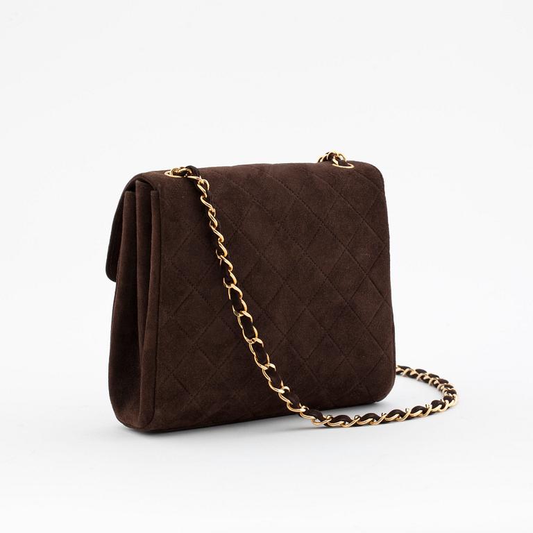 CHANEL, a brown suede shoulderpurse.