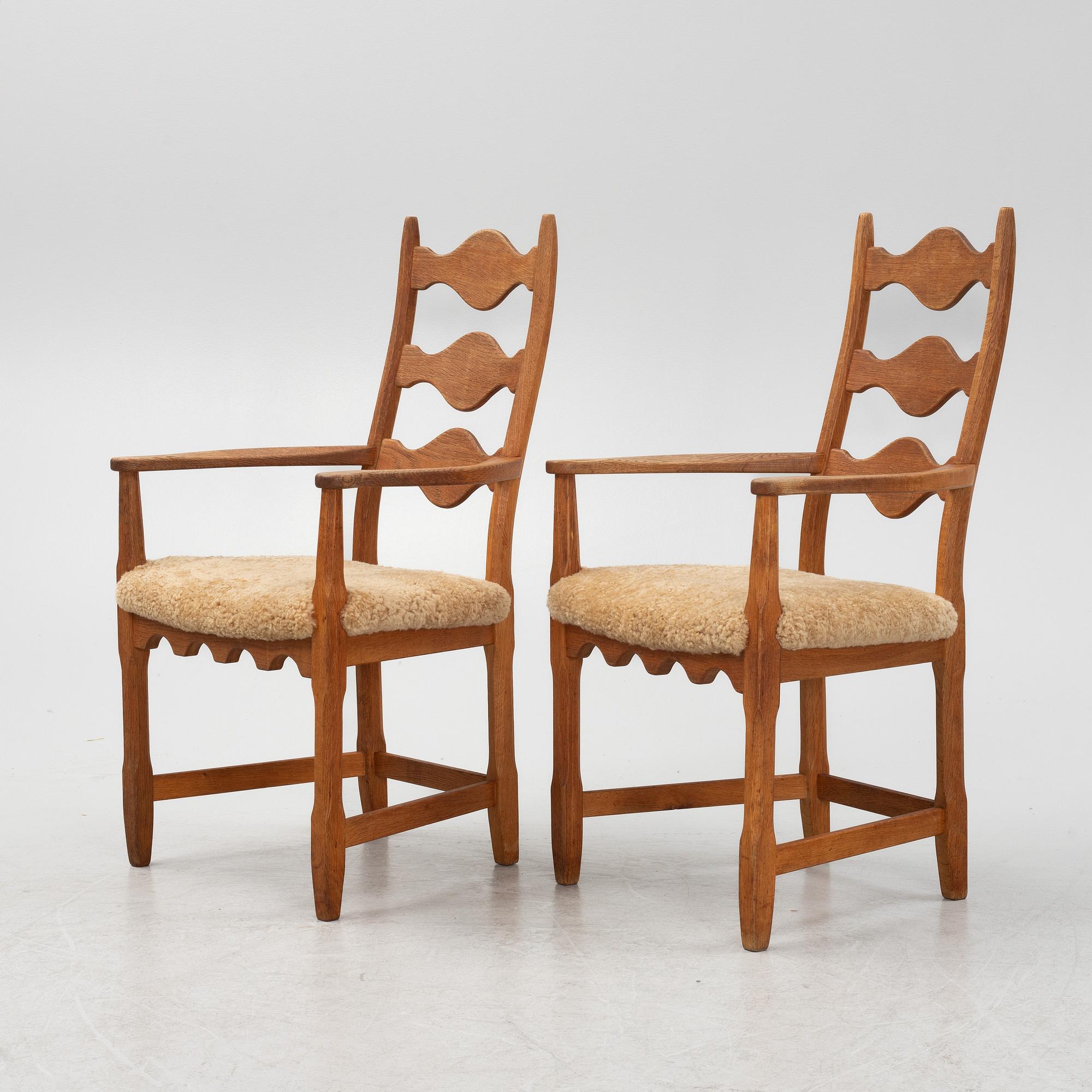Henning Kjærnulf, a pair of oak 'Razorblade' armchairs with new sheepskin upholstery, from EGK, Demark, 1960s.