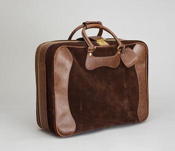 A 1970s brown suede suitcase by Gucci.