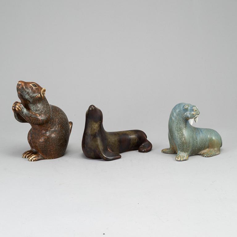 GUNNAR NYLUND, a set of thre stoneware sculptures; a squirrel, a walrus and a seal, Rörstrand, Sweden.