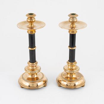 A pair of brass candlesticks, around the year 1900.