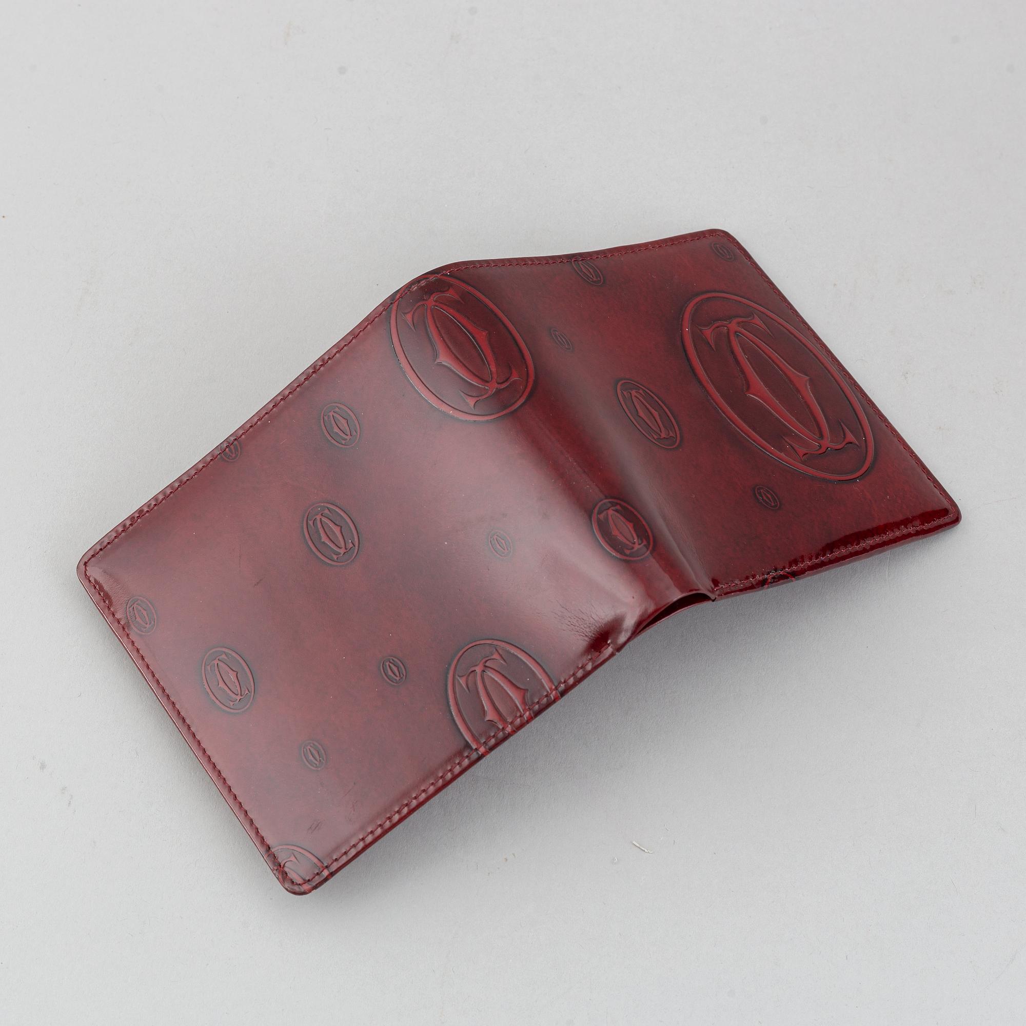 Cartier, a burgundy patent leather handbag and wallet.