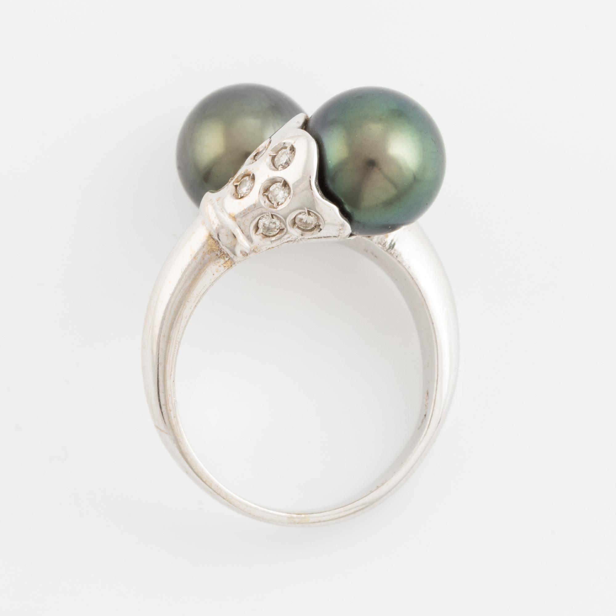 Cultured black pearl and brilliant cut diamond cross over ring.