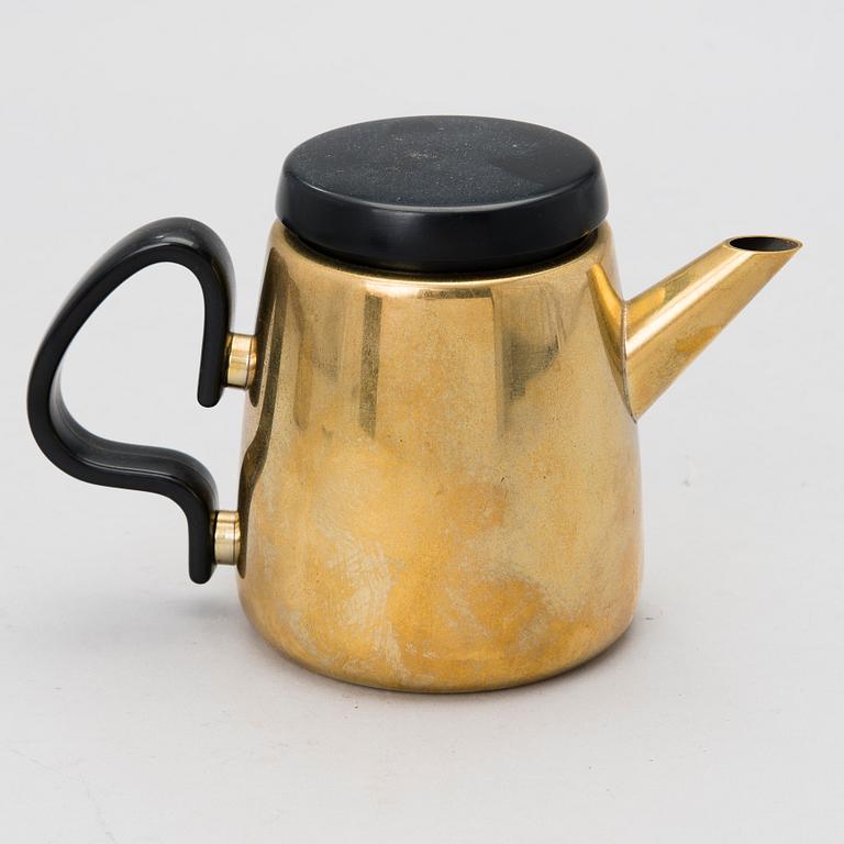 A tea/ coffee pot, a sugar bowl and a cream jug in brass for Georg Jensen, Denmark. Design year 1970.