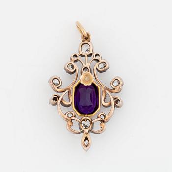 A silver and gold pendant set with a faceted amethyst and old- and rose-cut diamonds.