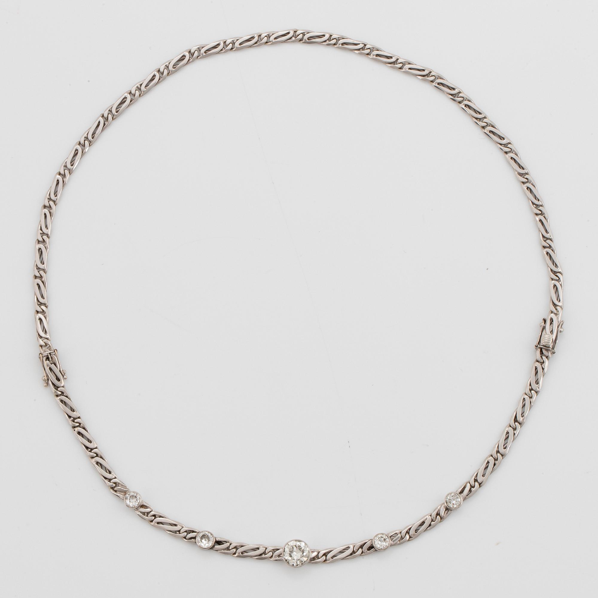 An 18K white gold necklace/bracelet combination set with round brilliant-cut diamonds.