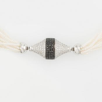 An 18K white gold Gaudy clasp with white and black diamonds.
