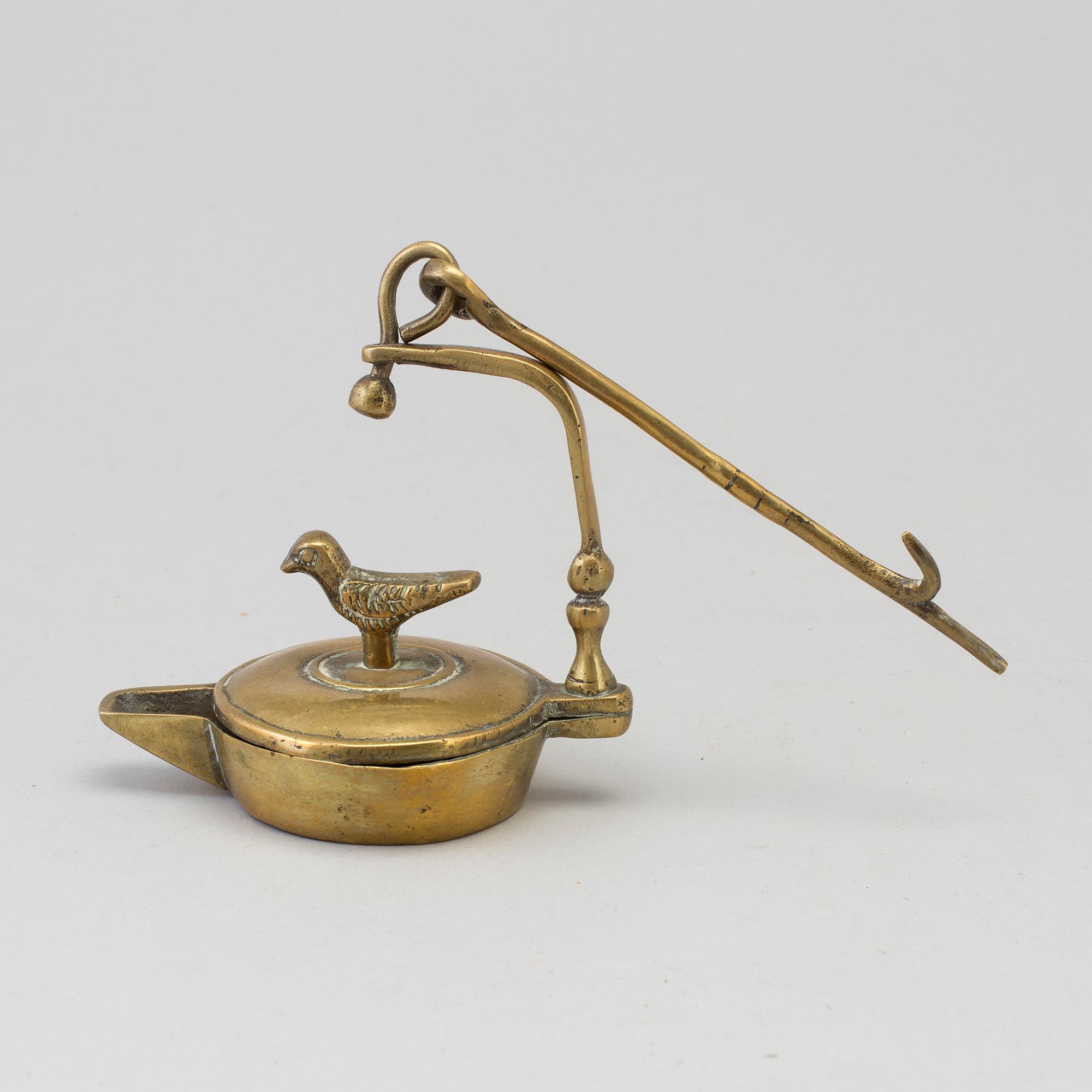 An 18th century bronze oil lamp.