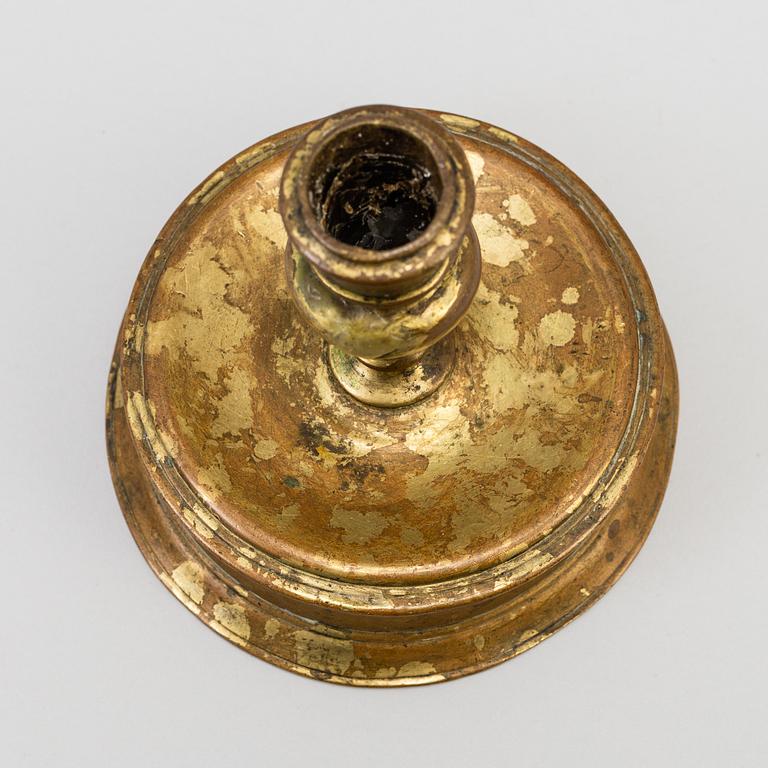 A 17th century bronze candlestick.