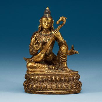 A Sinotibetan jeweled gilt bronze figure of Sarasvati, Qing dynasty, 19th Century.