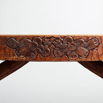 Gustaf Fjaestad, an Art Nouveau carved pine table, Arvika Sweden 1914, a double to the table in the Thiel Collection,
