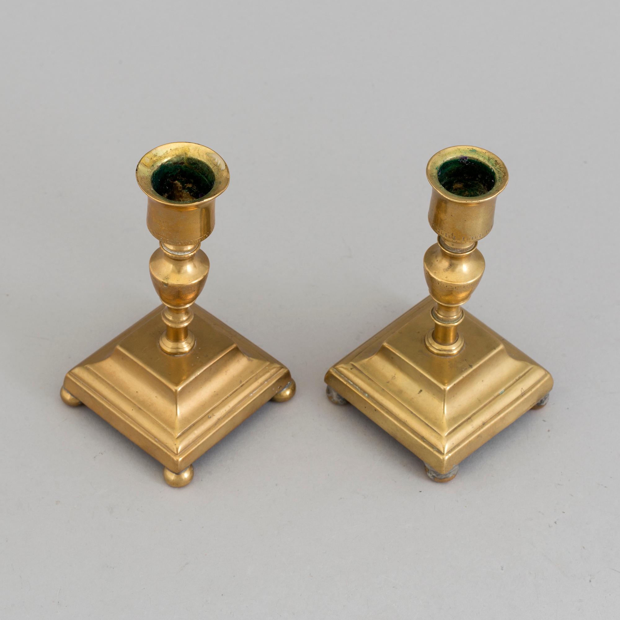 A pair of brass candlesticks, 18th Century.