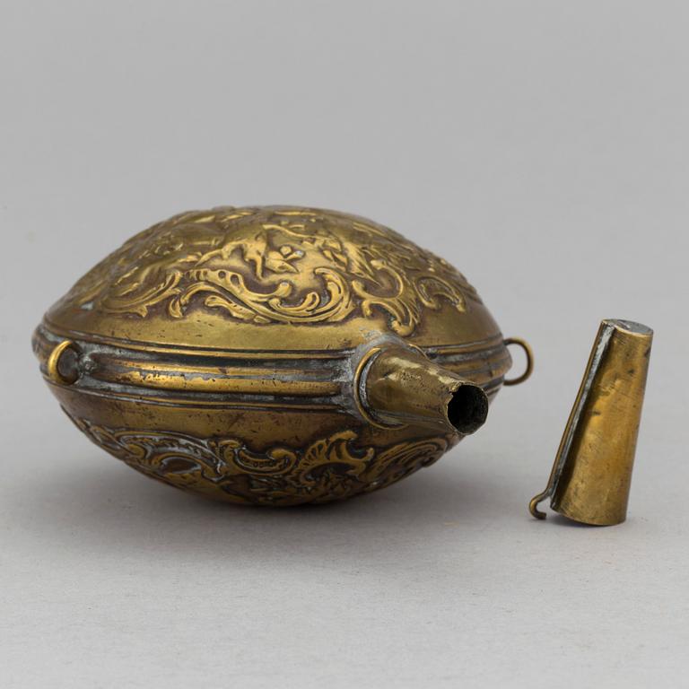 A mid 18th century brass powder flask.