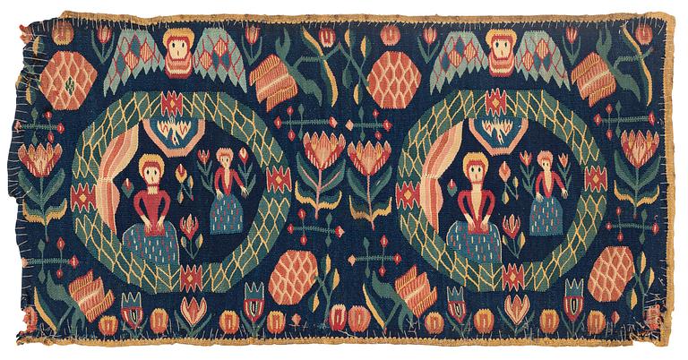 A carrige cushion, "Bebådelsen", tapestry weave, ca 95 x 47,5 cm, Skåne, 1800-1830.