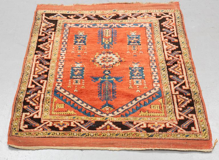 A rug, an antique Anatolian, ca 128 x 104,5-108 cm (as well as ca 8-10 cm flat weave at the ends).