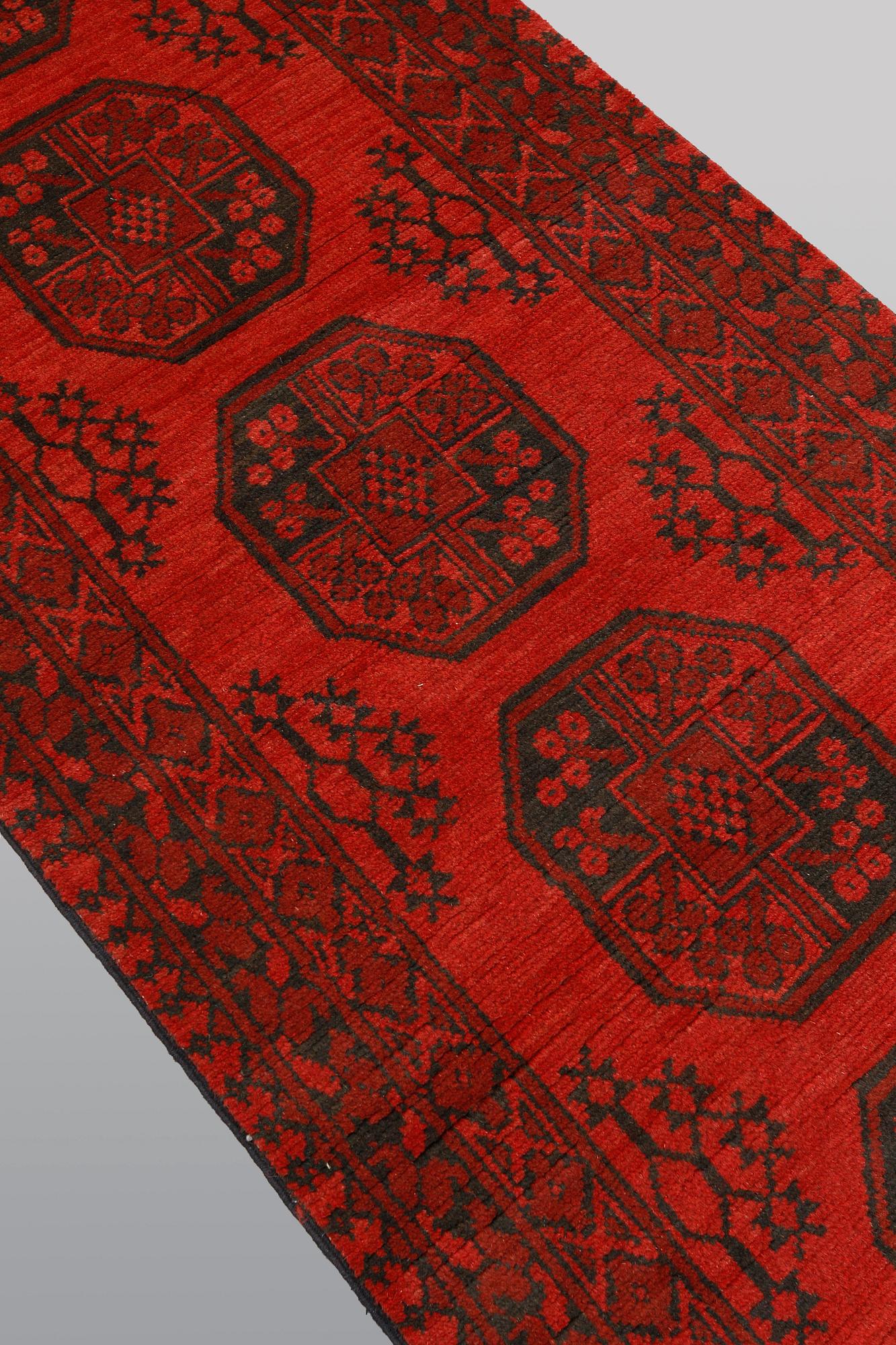 An Afghan runner, ca 390 x 79 cm.