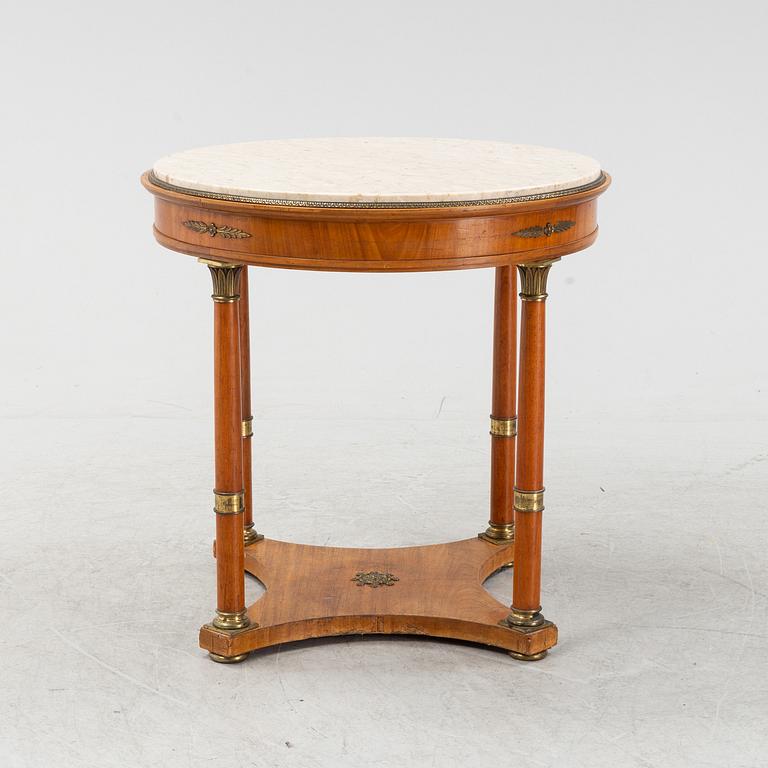 A table with marble top and brass mountings from around year 1900.