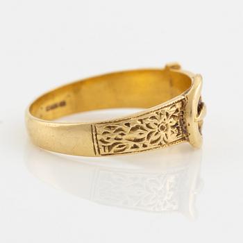 An 18K gold ring.