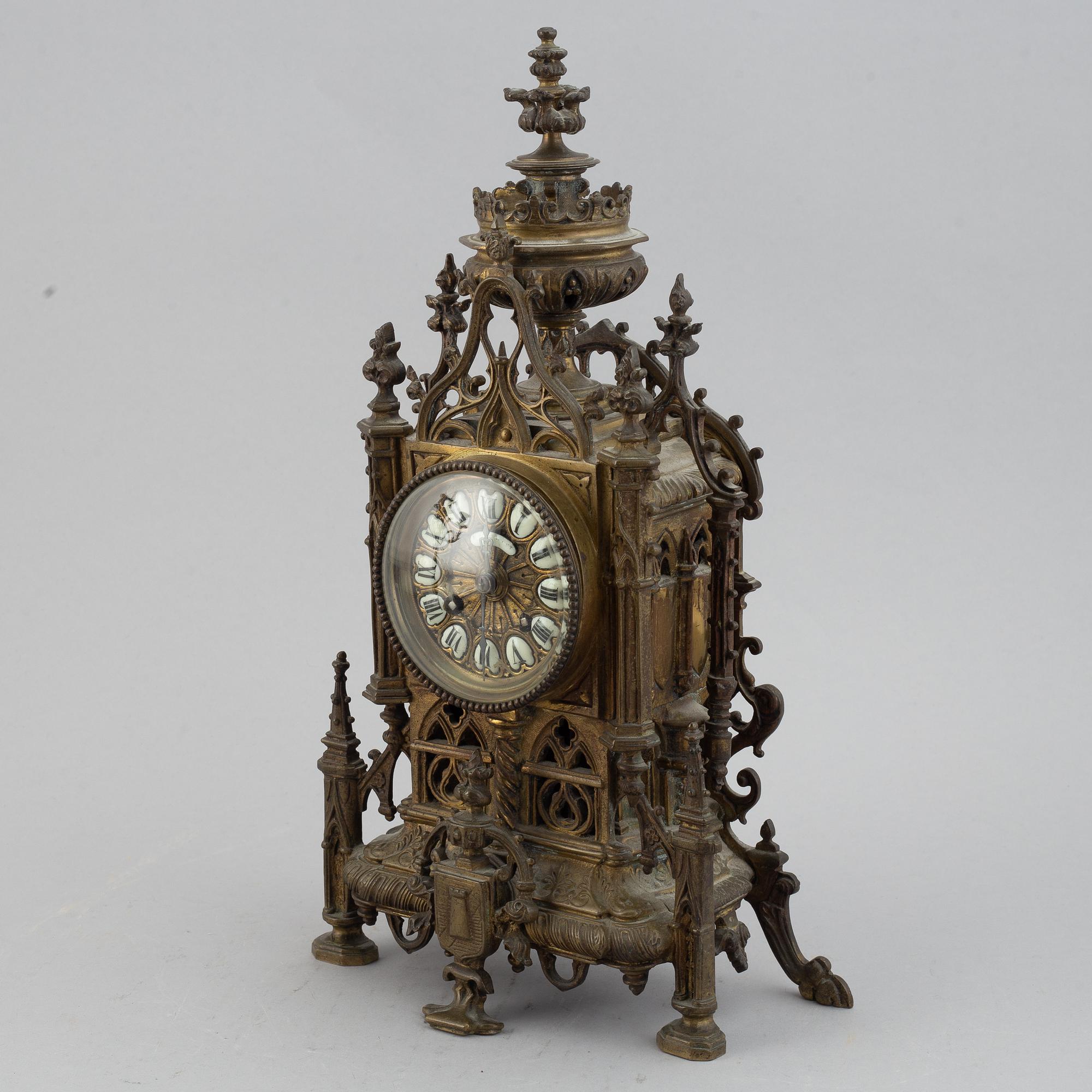 A mantle clock with pair of candelabra, late 19th century.
