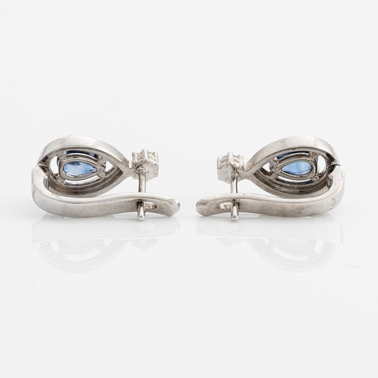 A pair of 14K gold earrings with faceted sapphires and round brilliant-cut diamonds.