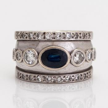 A 9K white gold ring,  with an oval sapphire and diamonds totalling approximately 0.62 ct.