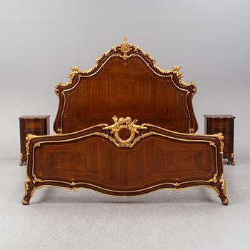 a set of a mahogany veneered and guilded rococo-style bed and two bedside tables.