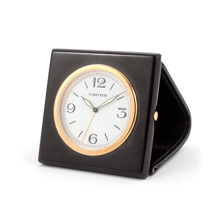 CARTIER, a travelwatch in a black leather case.