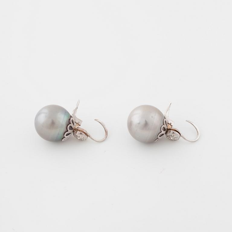 A pair of cultured pearl and brilliant cut diamond earrings.