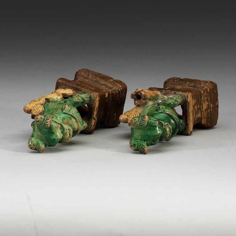 A pair of brown, green and yellow glazed joss stick holders, Qing dynasty (1644-1912).