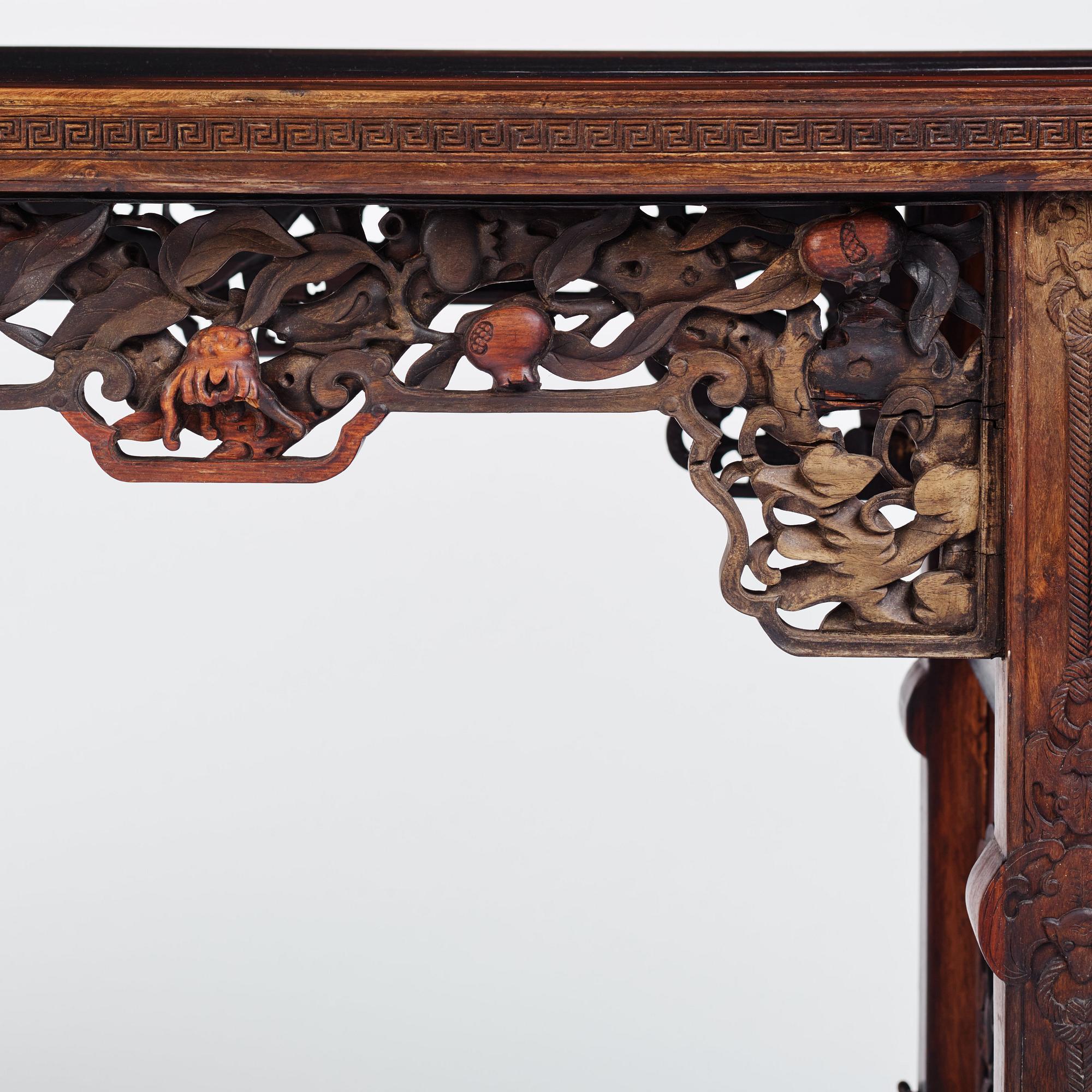 A massive zitan recessed-leg long table 'Jiaotousun Qiotouan', Qing dynasty, 19th century.