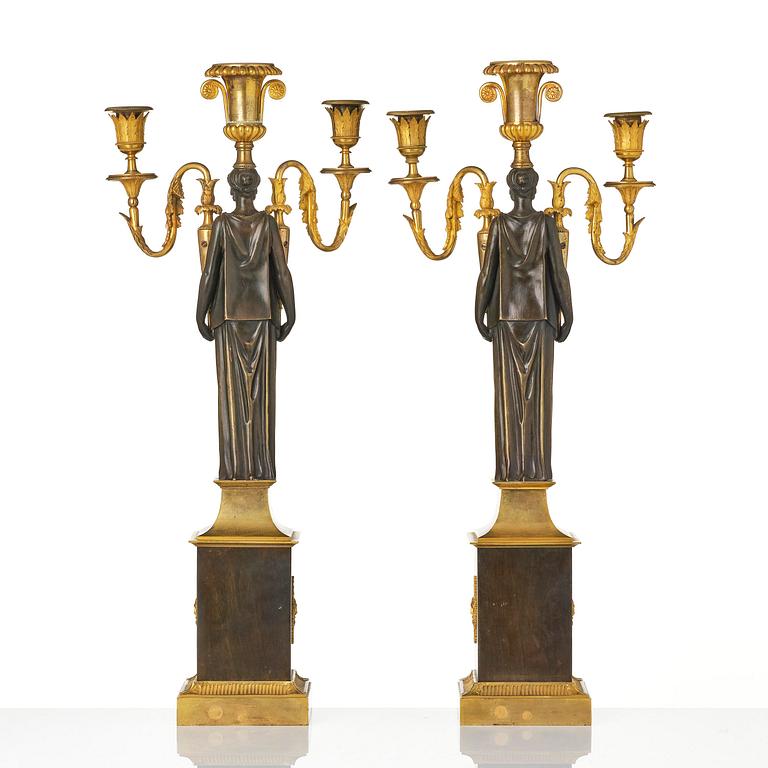 A pair of French Empire ormolu three-branch candelabra, Paris, early 19th century.