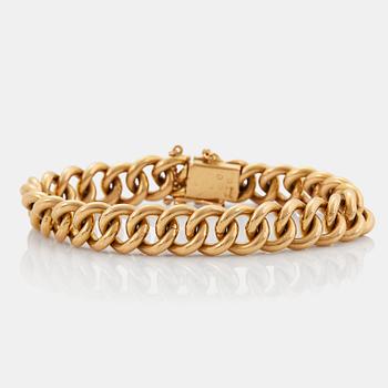 An 18K gold bracelet.