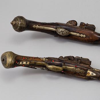 Two 19th century flintlock pistols.