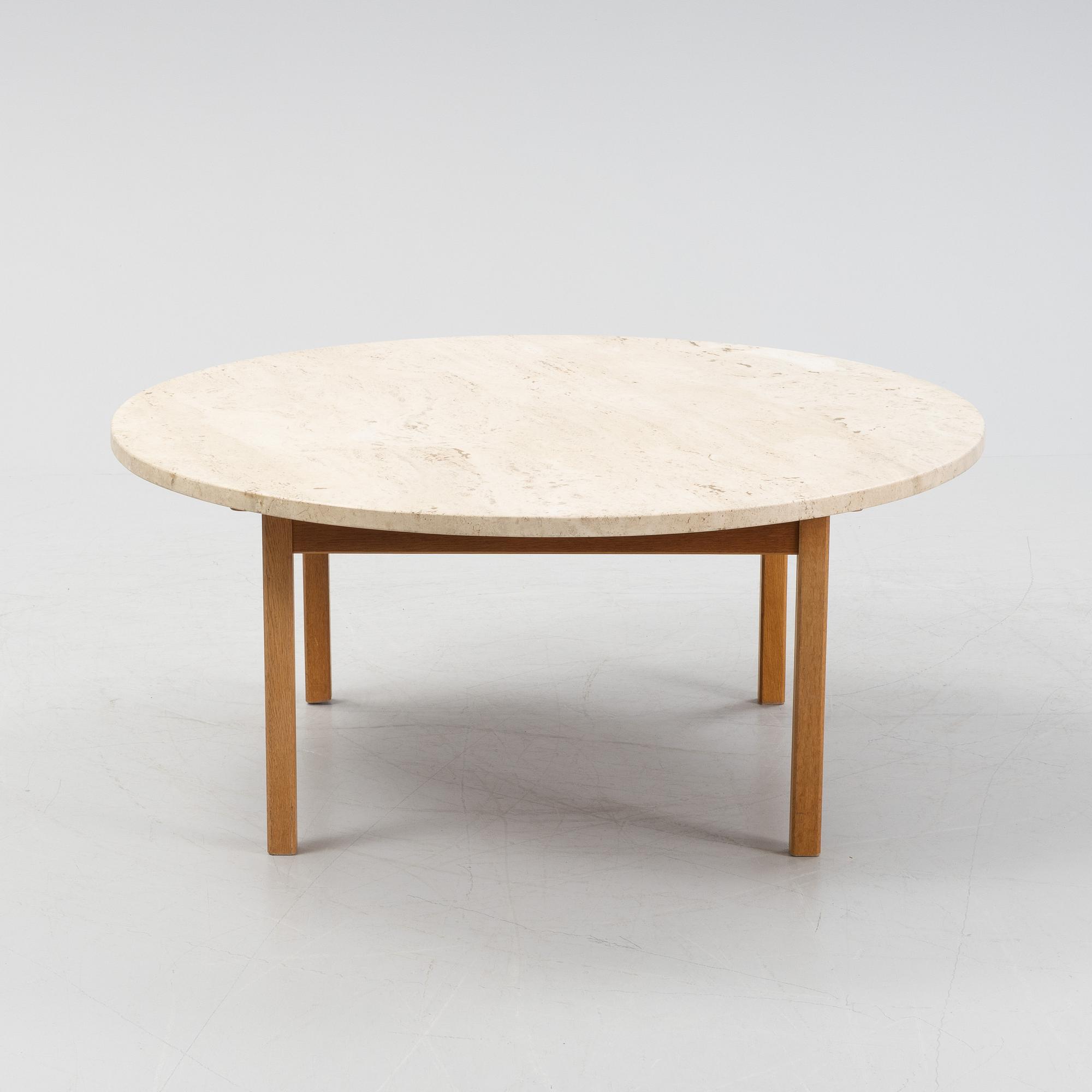 An oak coffee table with a later travertine top.