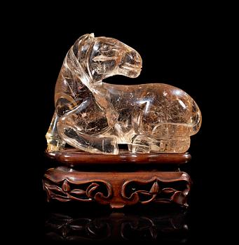 1348. A smoky quartz figure of a reclining horse, China early 20th Century.
