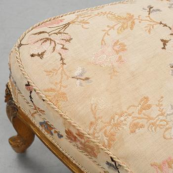 A Louis XV-style bergère armchair with stool, second half of the 19th century.