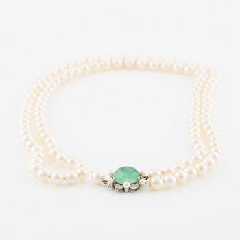 Pearl necklace, two pieces, cultured pearls, one with a clasp, Carlman, 18K white gold with cabochon-cut emerald and diamonds.