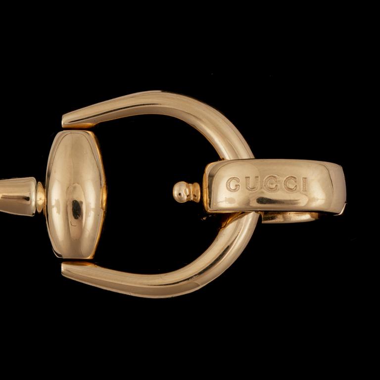 A Gucci "Horsebit" bracelet.