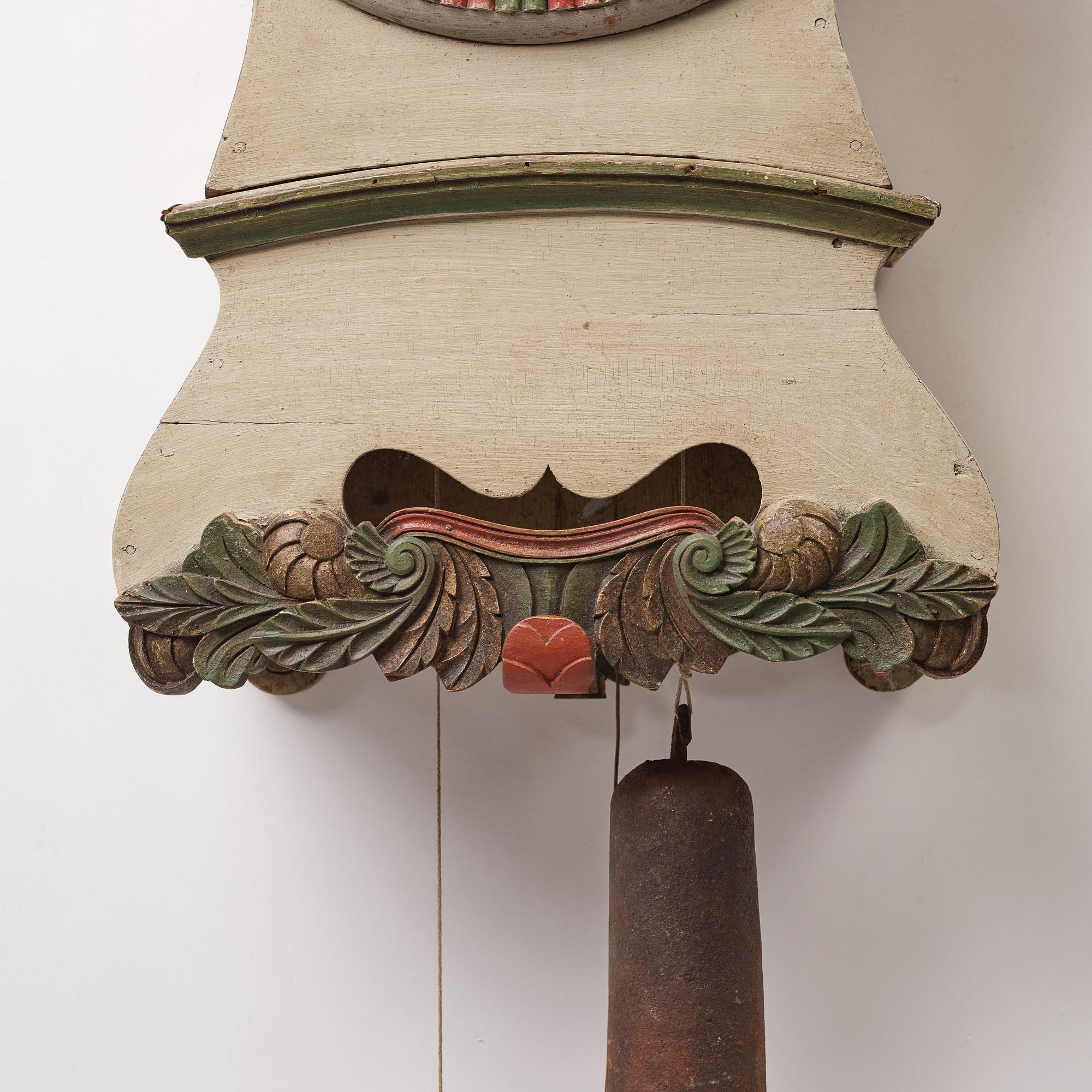 a painted wall pendulum clock from Ångermanland in the first half of the 19th century.