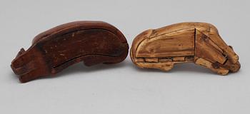 Two 19th-20th century birch snuffboxes in the shape of lying dogs.