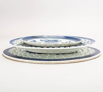 A set of two Chinese blue and white 18th century plates and strainer.