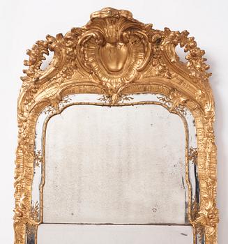 A Swedish rococo carved giltwood and gesso mirror, later part of the 18th century.