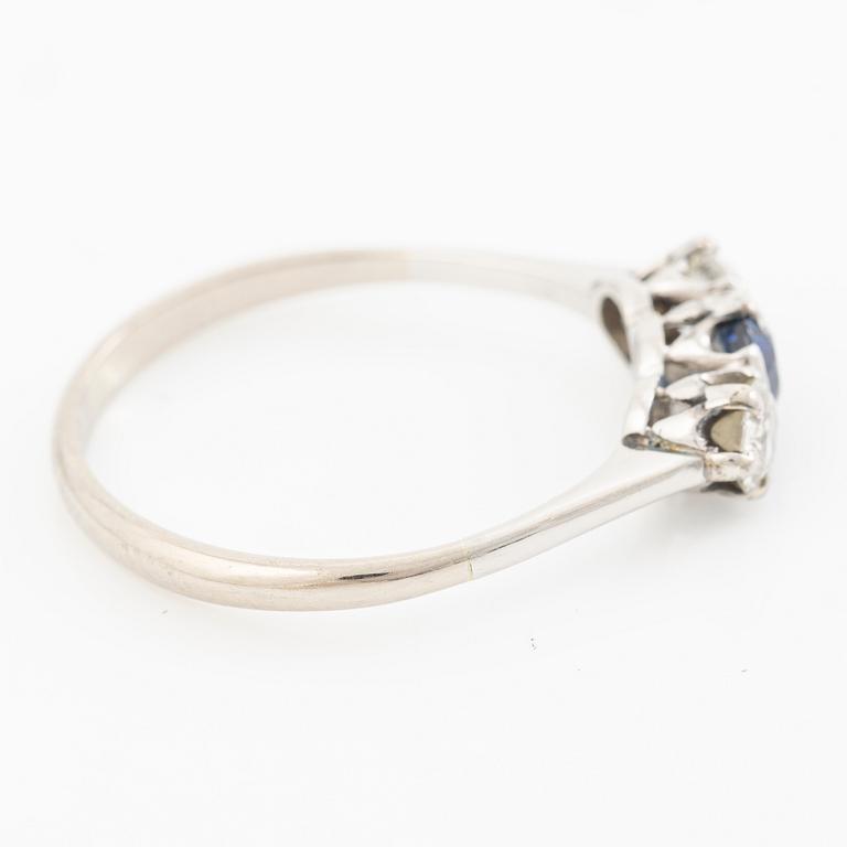 18K gold ring with two old-cut diamonds and a blue stone.