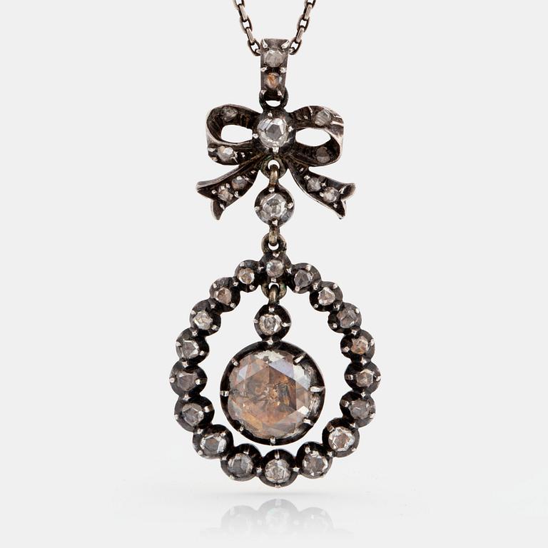 A silver pendant set with rose-cut diamonds.