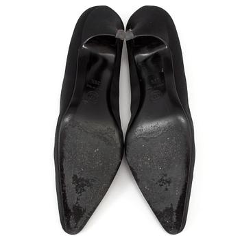 Pumps by Chanel.